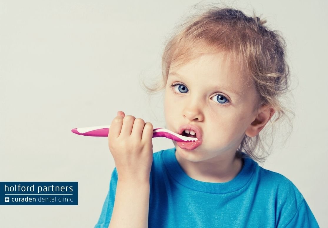 Main image for the "Yellow Teeth in Children" blog which is a picture of a young girl brushing her teeth