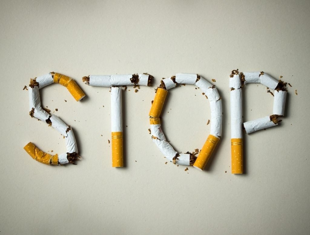 Image of cigarettes cut in pieces and arranged to spell "stop"
