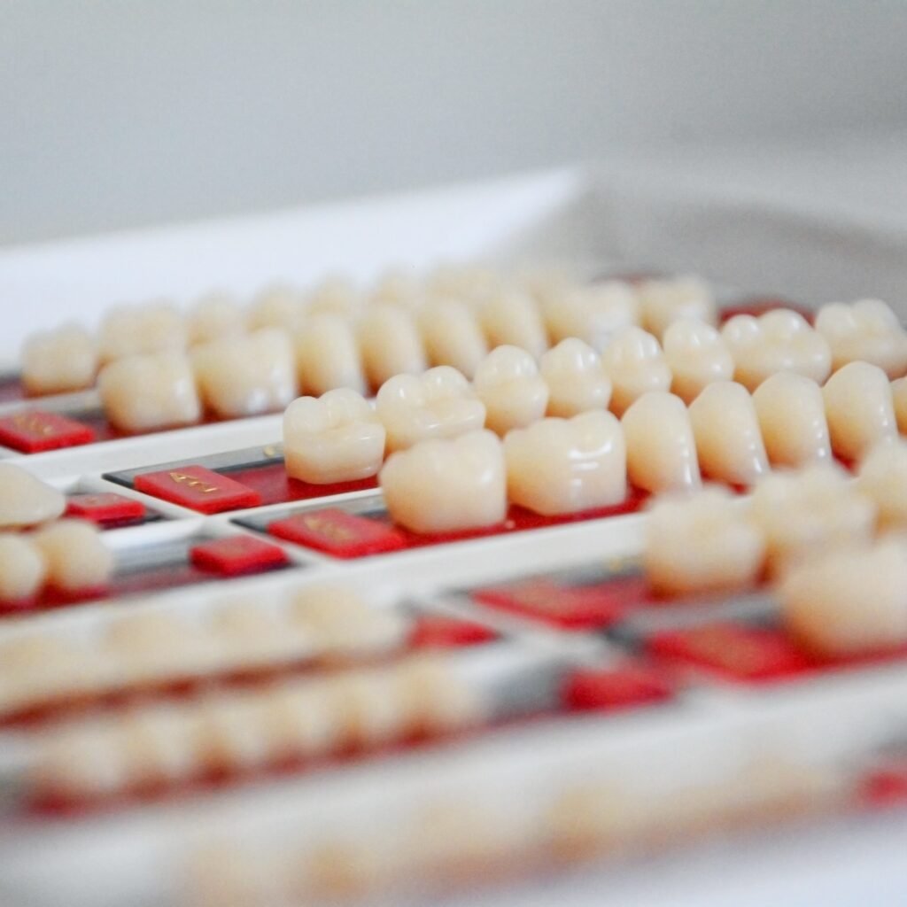 Image of a selection of dental crowns and bridges arranged in compartments